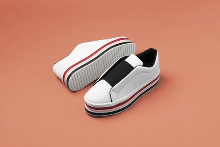 Stylish women's sneakers on color background, top view