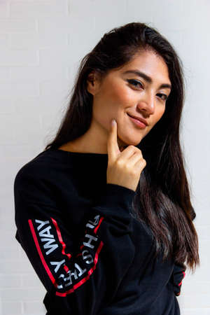 Latin mexican young woman inviting to kiss her on the cheek. Sexy look of woman.のeditorial素材