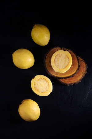 Yellow guava on black background, still life style. Healthy dietの写真素材