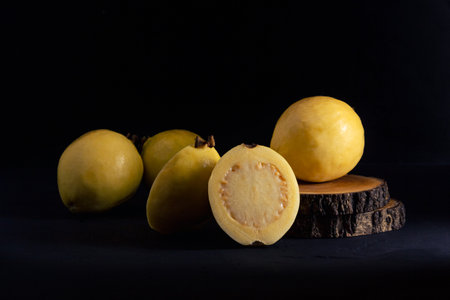 Yellow guava on black background, still life style. Healthy dietの写真素材