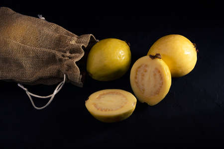 Yellow guava on black background, still life style. Healthy dietの写真素材