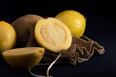 Yellow guava on black background, still life style. Healthy dietの写真素材