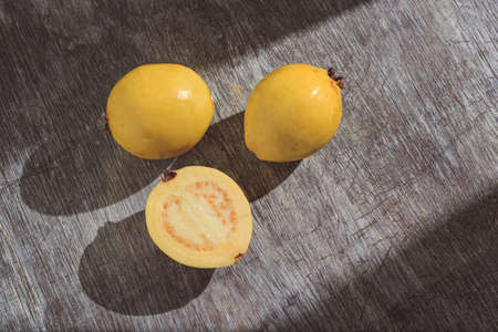 Yellow guava on wooden background. Vitamin C, healthy fruit diet.の写真素材
