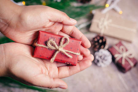 Mini christmas gifts on wooden background with warm and cold tonesの写真素材
