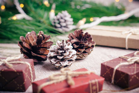 Mini christmas gifts on wooden background with warm and cold tonesの写真素材