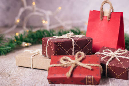 Mini christmas gifts on wooden background with warm and cold tonesの写真素材