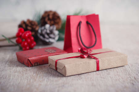 Mini christmas gifts on wooden background with warm and cold tonesの写真素材