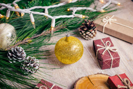 Mini christmas gifts on wooden background with warm and cold tonesの写真素材