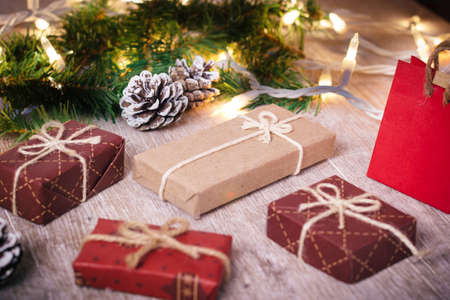 Mini christmas gifts on wooden background with warm and cold tonesの写真素材