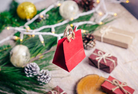 Mini christmas gifts on wooden background with warm and cold tonesの写真素材