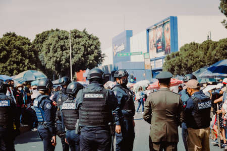 Police detain people with caution tape prior to the May 5 parade