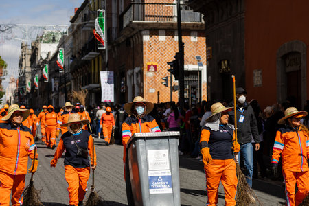Cleaning personnel known as "naranjitas" parade in the commemoration of the independence of Mexicoのeditorial素材