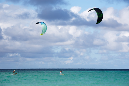 Two people kite surfing at the beach