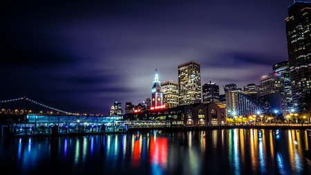 Ferry Building and Bay Bridge illuminated at night in San Francisco California USAの写真素材