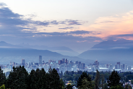 Vancouver skyline at dusk as seen from Queen Elizabeth Park British Columbia Canadaの写真素材