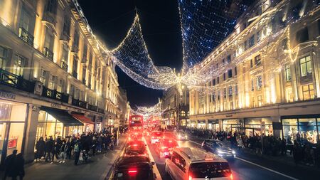 London, UK - December 26, 2016: Regent Street angels holiday lights with crowds of shoppers in London, United Kingdomのeditorial素材