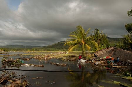 Tsunami victims collects items from a damaged house in Carita district, Banten province, Indonesia on December 28, 2018のeditorial素材
