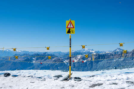 Warning sign of possible ski fall from the mountain. Accident.の写真素材