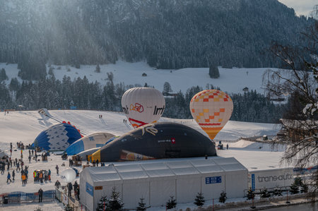 Chateau-d'Oex,Vaud, Switzerland - 23 January 2023: Hot Air Balloon. People working for the preparation of hot air ballooning before flight. International balloon festival.のeditorial素材