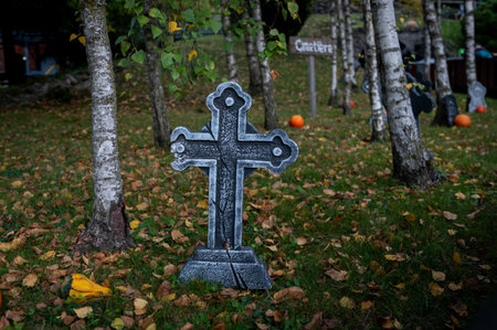 Spooky Halloween Cemetery with Cross and Pumpkin on ground.の写真素材