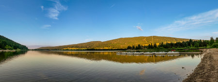 Golden Sunset Panorama at Lac des Rousses with Paddle Boats. Jura Mountains, Franceの写真素材