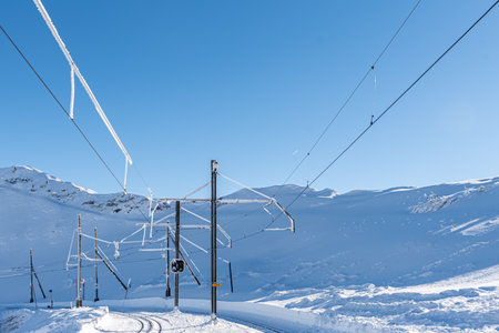 Winter Snowy Railway Line in the Swiss Alps in Switzerland. Rochers-de-Naye, Vaud, Switzerland.