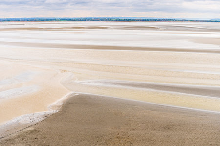 Landscape of Mont Saint-Michel Bay Sand Textures and Tidal Patterns. Normandy, France.