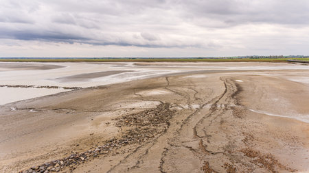 Landscape of Mont Saint-Michel Bay Mudflats and Tidal Patterns. Normandy, France.