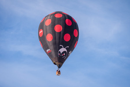 Chateau d'oex, Vaud Canton, Switzerland - 1st February 2026: Hot Air Balloon Flying Over Swiss Alps in Switzerland Winter.のeditorial素材