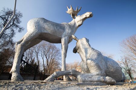 Sculpture of elk in the central park in Ryazan city against the cloudless blue skyの写真素材