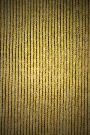 Close up of orange colored corduroy fabric.
