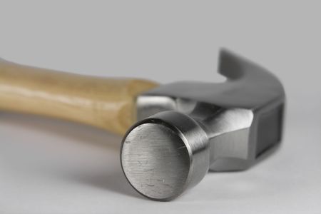 Metal hammer isolated over a gray colored background.の写真素材