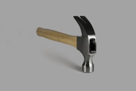 Isolated metal hammer over a gray colored background.の写真素材