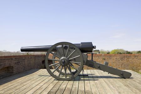 Old historical canon at the edge of a fortress's brick wall.の写真素材
