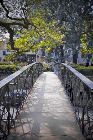 Man made bridge crossing with garden and trees on the other end.の写真素材