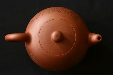 Chinese tea pot isolated on a black background.の写真素材
