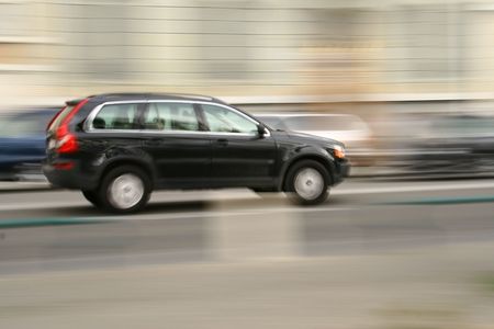 Panning shot of a moving vehicle on the road.