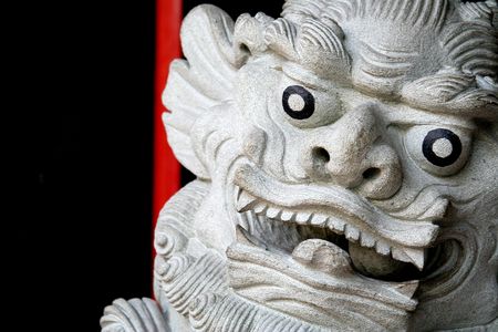 Generic stone statue of a chinese lion. Texture is stone is rough, not noise (shot at ISO100).の写真素材