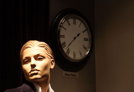 Headshot of a generic mannequin with a wall clock. Background slightly textured, not noise.の写真素材