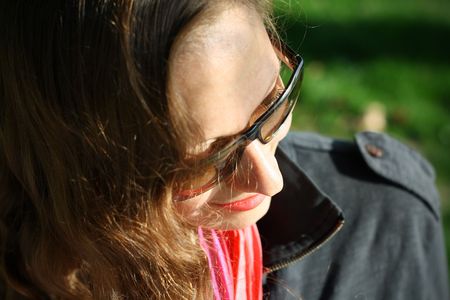 Business woman removing her dark glasses and looking at you from the top of her glasses.