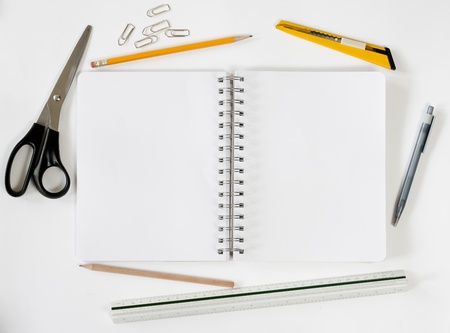 Open notebook with various stationeries or office supplies, white blank pagesの写真素材