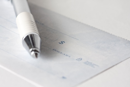 Close up shot of a cheque or cheque with a penの写真素材