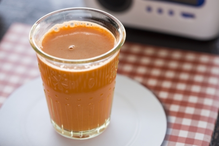 Freshly pressed carrot juice in a clear glassの写真素材