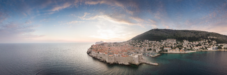 Panoramic aerial view of the old walled city or town of Dubrovnik, Croatia with blue cloudy skies and mediterranean seaの写真素材
