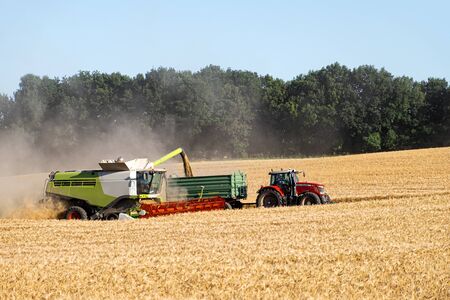 Rathmannsdorf, Germany - July 02, 2019: Harvester at work in Julyのeditorial素材