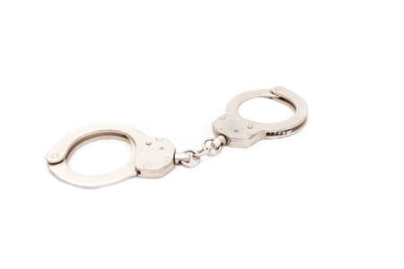 The clasped handcuffs on a white backgroundの写真素材