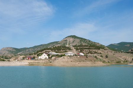 lake at township Sunny Valley on mountains background, Crimeaの写真素材