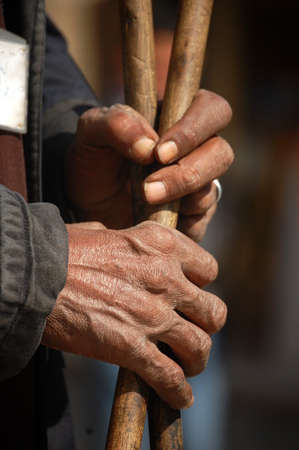 Hands of an old man holding a stickの写真素材