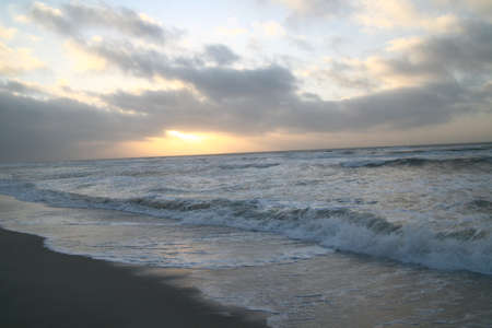 waves and clouds at the beachの写真素材