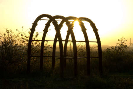 steel frame in front of the sunの写真素材